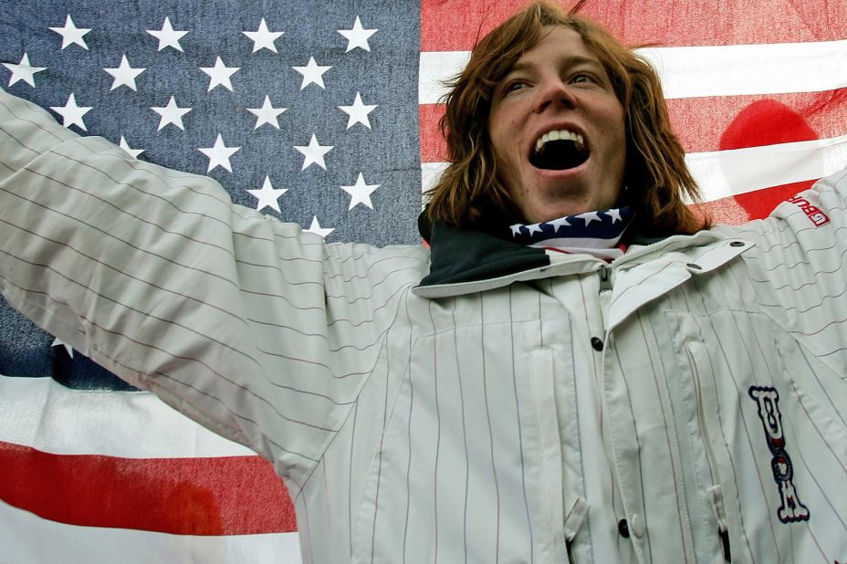 American snowboarder Shaun White celebrates on the podium after winning a gold medal at the 2006 Winter Olympics in Italy.