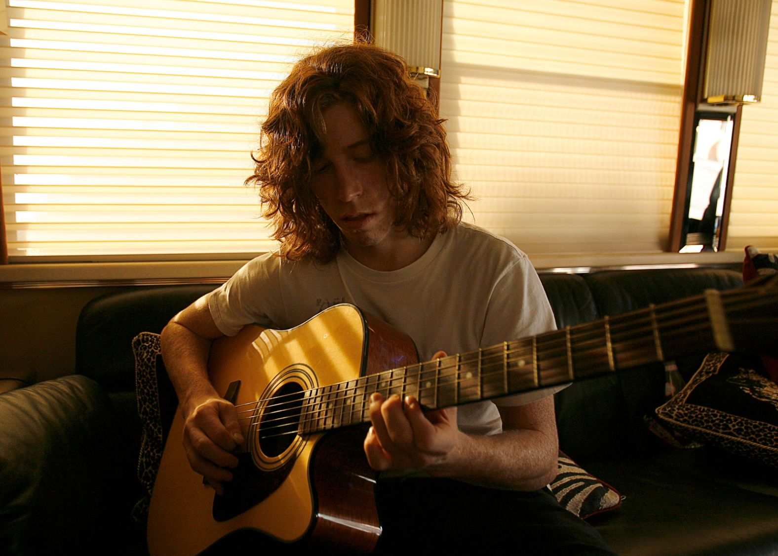 White plays the guitar on a tour bus while attending the X Games in 2006.