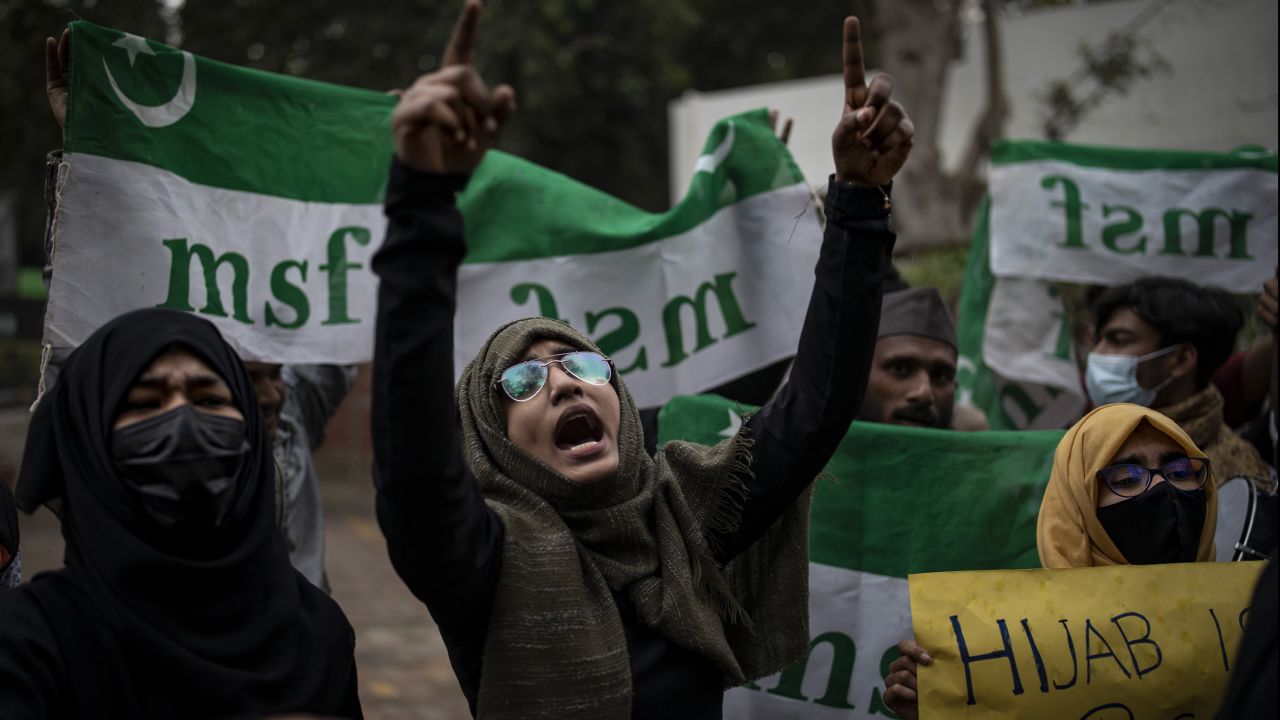 Indian Muslim woman shouts slogans during a protest in Delhi against the ban on Muslim girls wearing hijab in class.