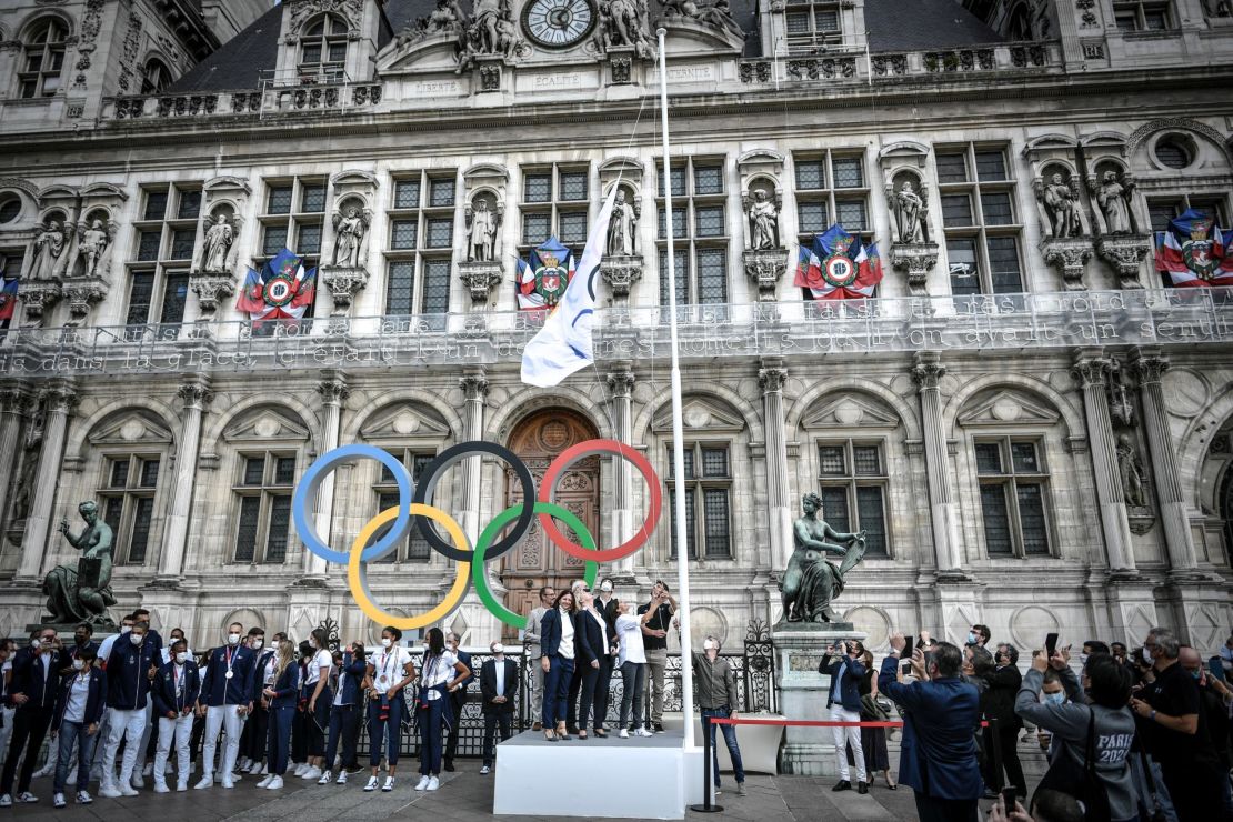 From left front row center: French Delegate Minister of Sports Roxana Maracineanu, President of the French National Olympic Committee Brigitte Henriques, Paris mayor Anne Hidalgo and President of the Paris Organizing Committee of the 2024 Olympic and Paralympic Games Tony Estanguet hoist the Olympic flag marking the handover from Japan to the next Games in Paris 2024.