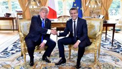 French President Emmanuel Macron (R) shakes hands with US President Donald Trump (L) during their meeting at the Elysee Palace in Paris on July 13, 2017, during Trump's 24-hour trip that coincides with France's national day and the 100th anniversary of US involvement in World War I.
Donald Trump arrived in Paris for a presidential visit filled with Bastille Day pomp and which the White House hopes will offer respite from rolling scandal backing home. / AFP PHOTO / POOL AND AFP PHOTO / ALAIN JOCARD        (Photo credit should read ALAIN JOCARD/AFP via Getty Images)