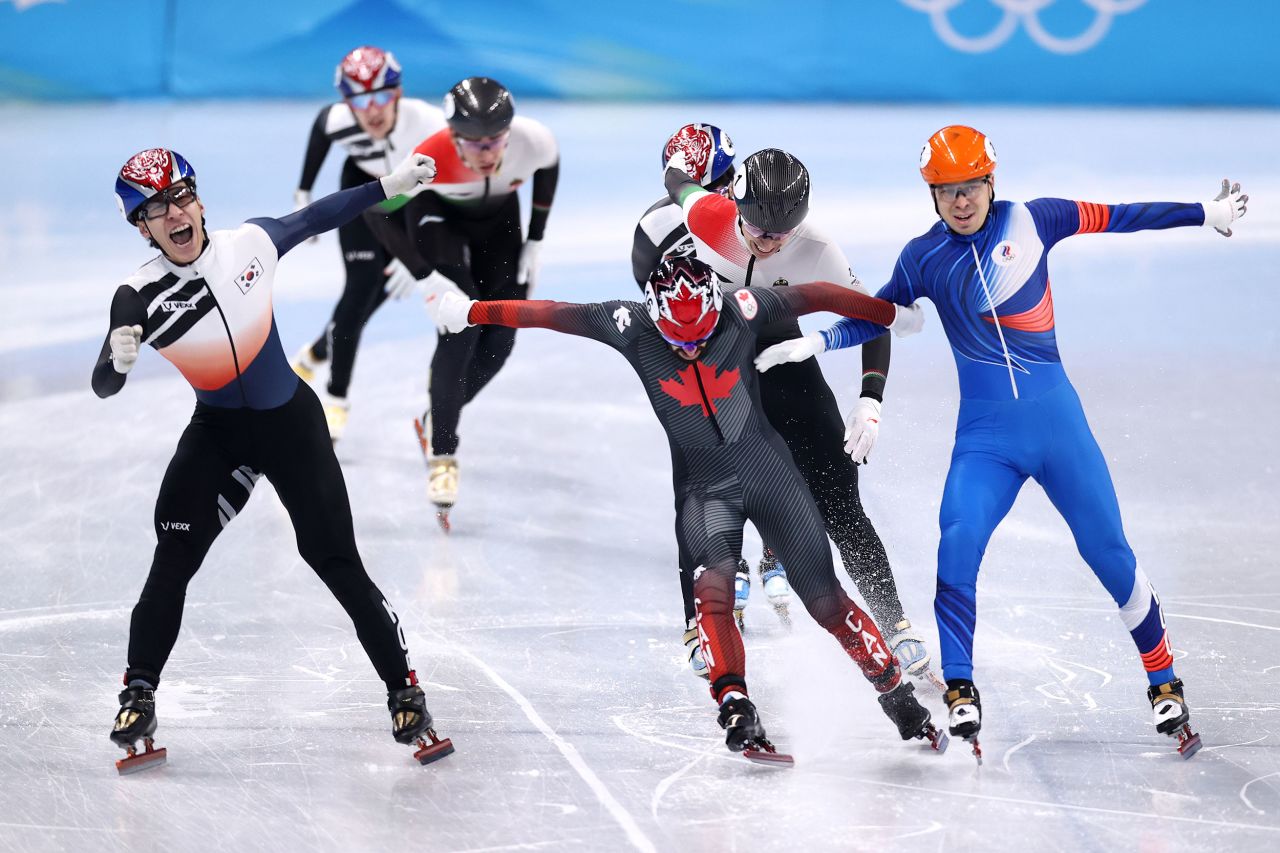 South Korea's Hwang Dae-heon, left, crosses the finish line ahead of Canadian Steven Dubois and Russian Semen Elistratov <a href="https://www.cnn.com/world/live-news/beijing-winter-olympics-02-09-22-spt/h_acd23d097451444f2b42b773063e413f" target="_blank">to win the 1,500-meter short track final</a> on February 9.