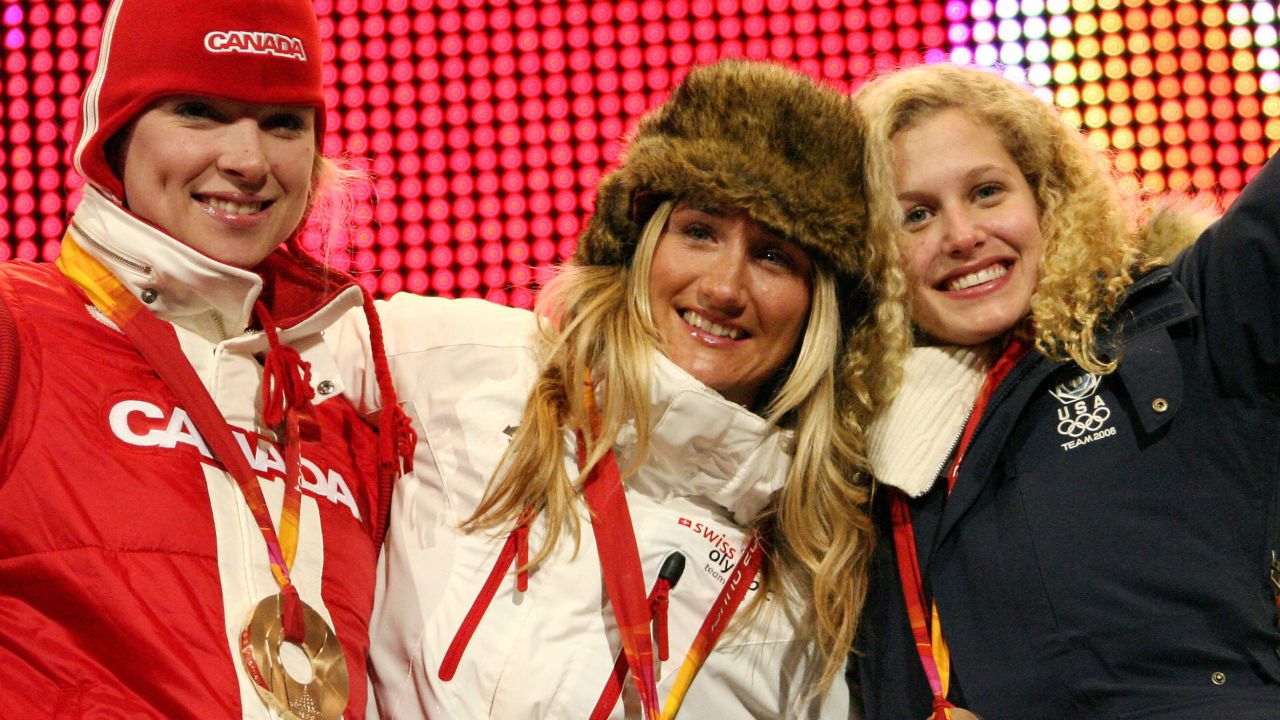 Silver medal winner Jacobellis (right), gold medal winner Tanja Frieden (middle) and bronze medal winner Dominique Maltais (left) celebrate on the pdium after the women's snowboard cross on February 17, 2006 in Turin, Italy.