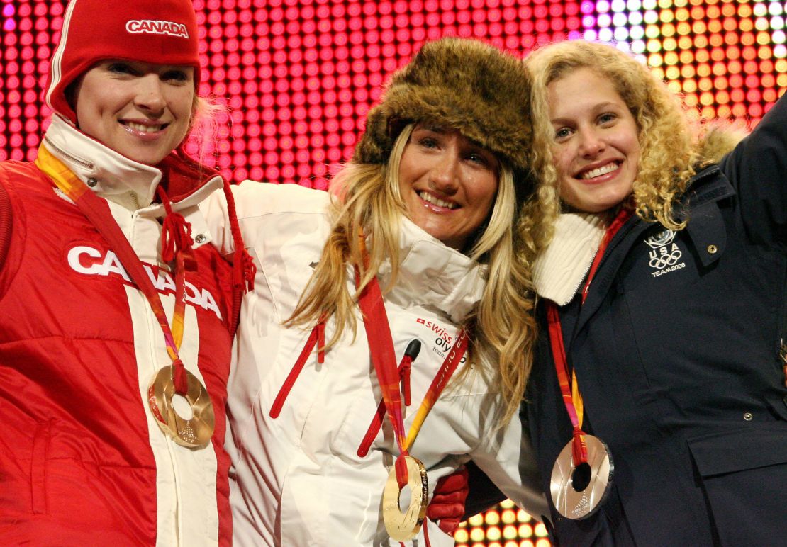 Silver medal winner Jacobellis (right), gold medal winner Tanja Frieden (middle) and bronze medal winner Dominique Maltais (left) celebrate on the pdium after the women's snowboard cross on February 17, 2006 in Turin, Italy.