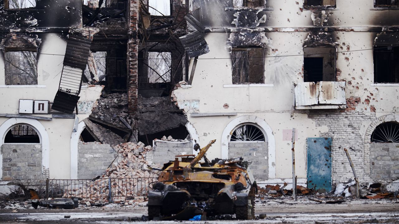 A burned military vehicle in front of a destroyed building in Uglegorsk, Ukraine, in February 2015.