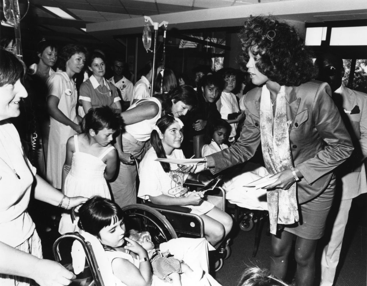Whitney Houston signs autographs at a children's hospital in Perth, Australia, on October 29, 1988.