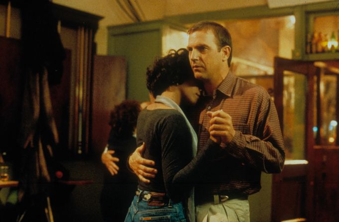Whitney Houston dances with Kevin Costner in "The Bodyguard."