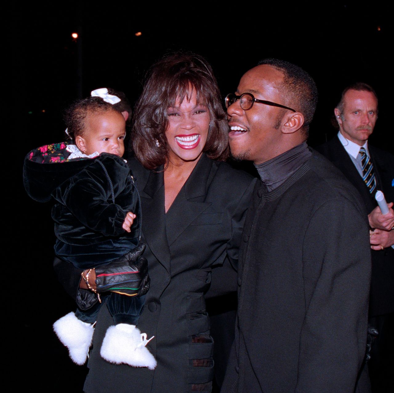 Whitney Houston, daughter Bobbi Kristina and husband Bobby Brown arrive at Tavern on the Green in New York City for Brown's 25th birthday celebration on February 4, 1994.