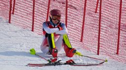 Mikaela Shiffrin, of the United States sits on the side of the course after skiing out in the first run of the women's slalom at the 2022 Winter Olympics, Wednesday, Feb. 9, 2022, in the Yanqing district of Beijing. (AP Photo/Robert F. Bukaty)