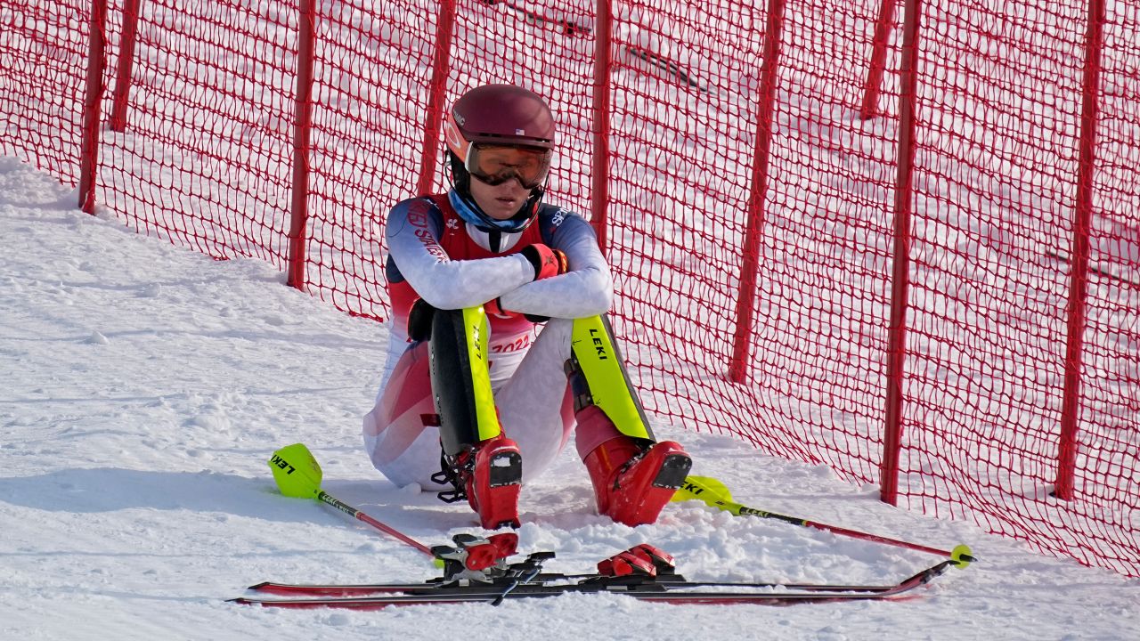 Mikaela Shiffrin sits on the side of the course after skiing out in the first run of the women's slalom.