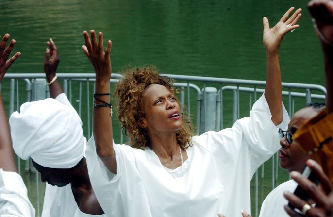 Whitney Houston and Bobby Brown are baptized in the Jordan River during a spiritual visit to Israel in May 2003.