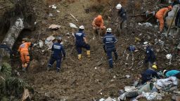 Rescuers work removing debris during the search of victims after a landslide caused by heavy rains in Pereira, Risaralda department, Colombia, on February 8, 2022. - The landslide left 7 dead and 29 injured in the Pereira neighbourhood on Tuesday, due to heavy rains in recent days, according to authorities. (Photo by Luis ROBAYO / AFP) (Photo by LUIS ROBAYO/AFP via Getty Images)