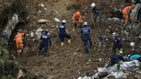 Rescuer workers remove debris after a landslide caused by heavy rains in Pereira, Colombia, on February 8.