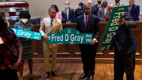Montgomery Mayor Steven Reed, second from left, poses with Fred Gray Jr. and Stanley Gray after the city council voted unanimously to rename Jefferson Davis Avenue after Gray's father, civil rights attorney Fred Gray last year.