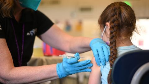A nurse administers a pediatric dose of the Covid-19 vaccine to a girl at a LA Care Health Plan vaccination clinic at Los Angeles Mission College last January.