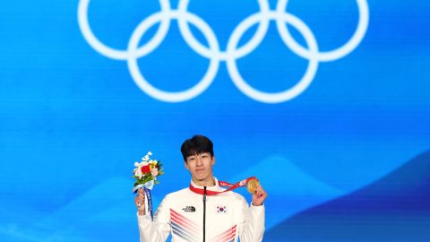 Hwang celebrates with his medal.