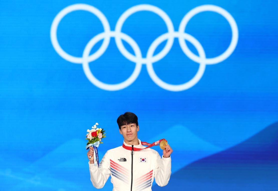 Hwang celebrates with his medal.