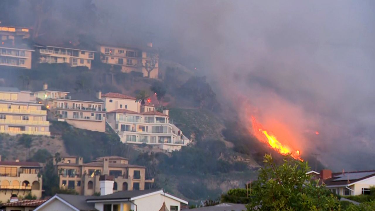 Residents in the Irvine Cove and Emerald Bay areas of Laguna Beach were placed under an immediate evacuation order due a brush fire that is threatening homes and other structures, officials said.