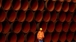 SASSNITZ, GERMANY - OCTOBER 19: A worker stands in front of pipes which lie stacked at the Nord Stream 2 facility at Mukran on Ruegen Islandon October 19, 2017 in Sassnitz, Germany. Nord Stream is laying a second pair of offshore pipelines in the Baltic Sea between Vyborg in Russia and Greifswald in Germany for the transportation of Russian natural gas to western Europe. An initial pair of pipelines was inaugurated in 2012 and the second pair is due for completion by 2019. A total of 50,000 pipes are currently on hand at Mukran, where they receive a concrete wrapping before being transported out to sea. Russian energy supplier Gazprom, whose board is led by former German chancellor Gerhard Schroeder, owns a 51% stake in Nord Stream. (Photo by Carsten Koall/Getty Images)