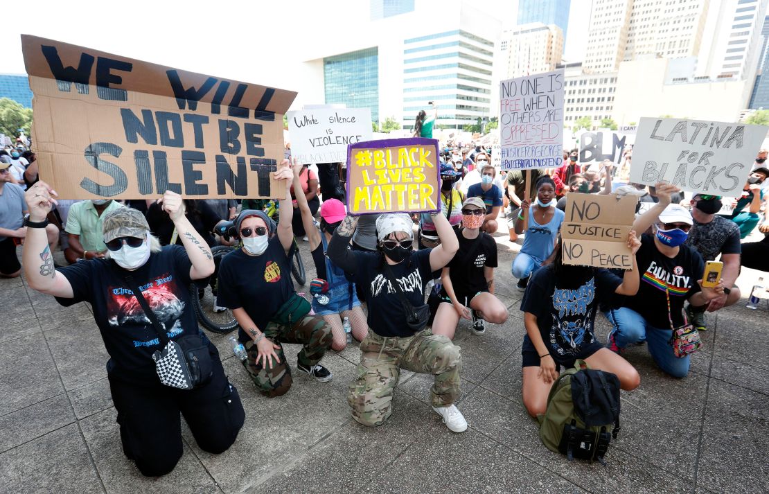 Protesters take a knee to demonstrate in front of Dallas City Hall in downtown Dallas, Texas, on Saturday, May 30, 2020. 