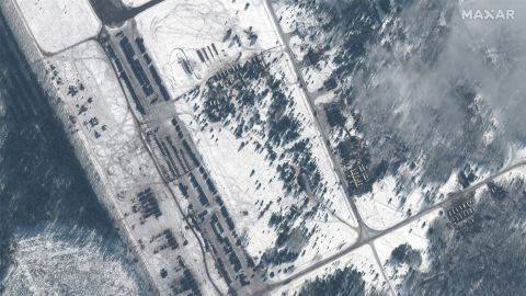 Maxar's satellite images show what they called a "new deployment of troops, military vehicles and helicopters" at the Zyabrovka airfield in Belarus.
