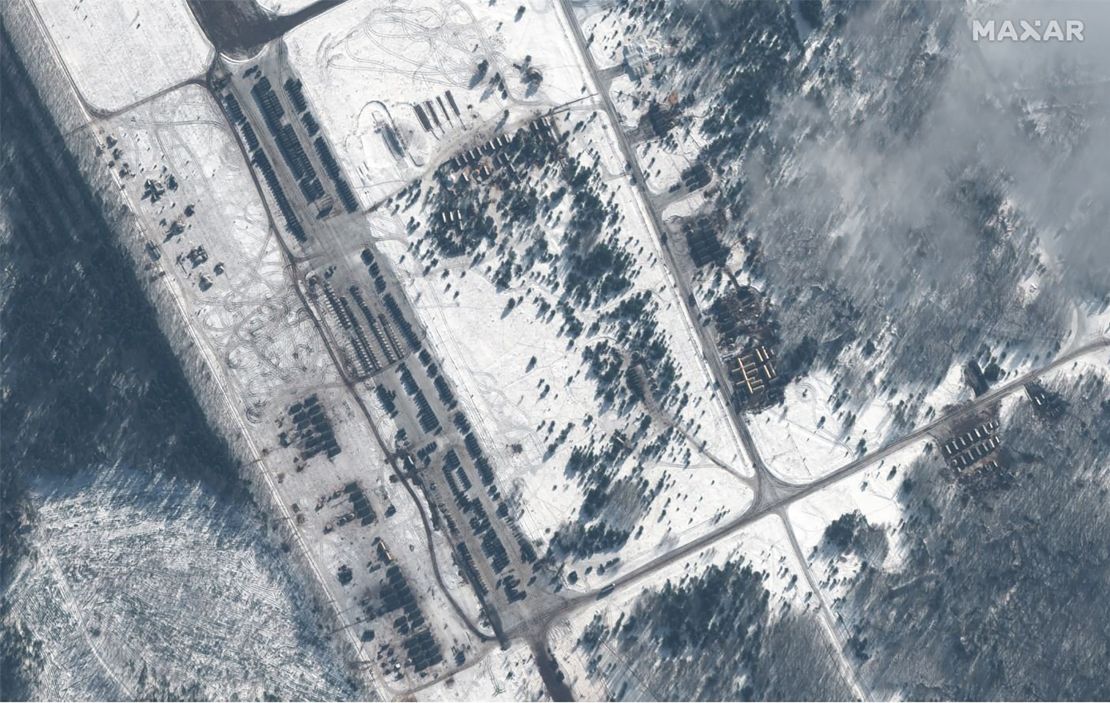 Maxar's satellite images show what they called a "new deployment of troops, military vehicles and helicopters" at the Zyabrovka airfield in Belarus.

