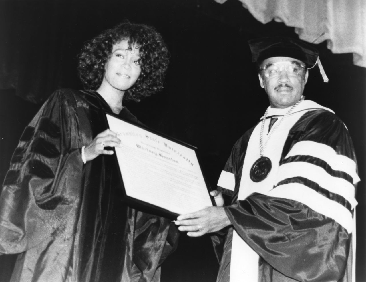 Whitney Houston receives an Honorary Doctorate of Humane Letters from Joseph B. Johnson, the president of Grambling University, in Louisiana, on July 21, 1988.