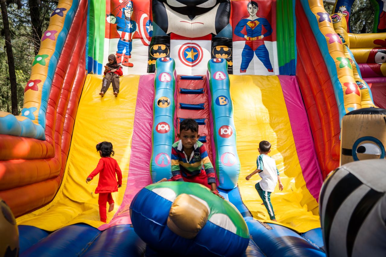 Children play on a bouncy castle at a beach in Narathiwat, Thailand, on Saturday, February 5.