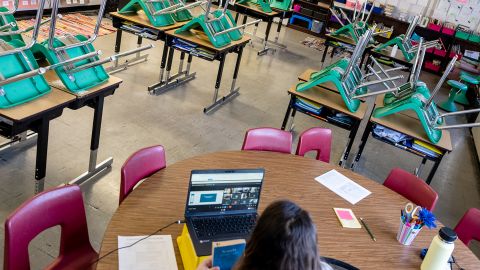 A teacher interacts with students virtually while sitting in an empty classroom during a period of Non-Traditional Instruction (NTI) at Hazelwood Elementary School on January 11, 2022 in Louisville, Kentucky. 
