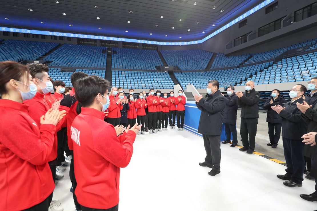 Chinese President Xi Jinping talks with athletes and coaches while visiting the Capital Gymnasium in Haidian District, Beijing in January, 2021.