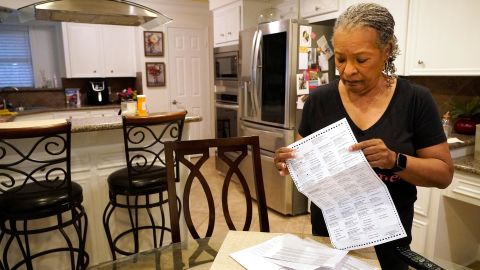 Pam Gaskin opens her mail ballot she received after multiple requests were rejected earlier this year at her home Monday, January 31, 2022, in Missouri City, Texas. 