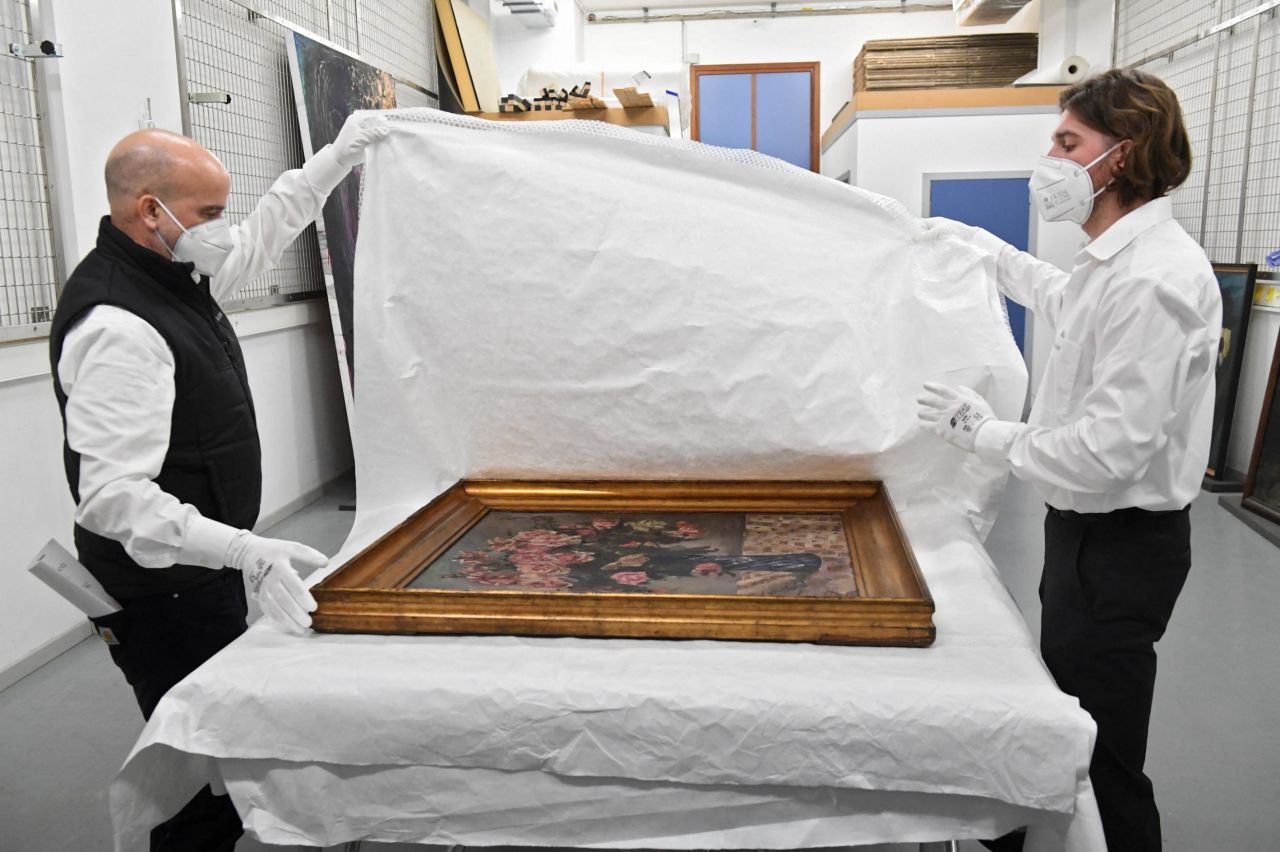 Staff members of the Royal Museums of Fine Arts pack "Blumenstilleben" ("Flowers") by Lovis Corinth, preparing it for transportation.