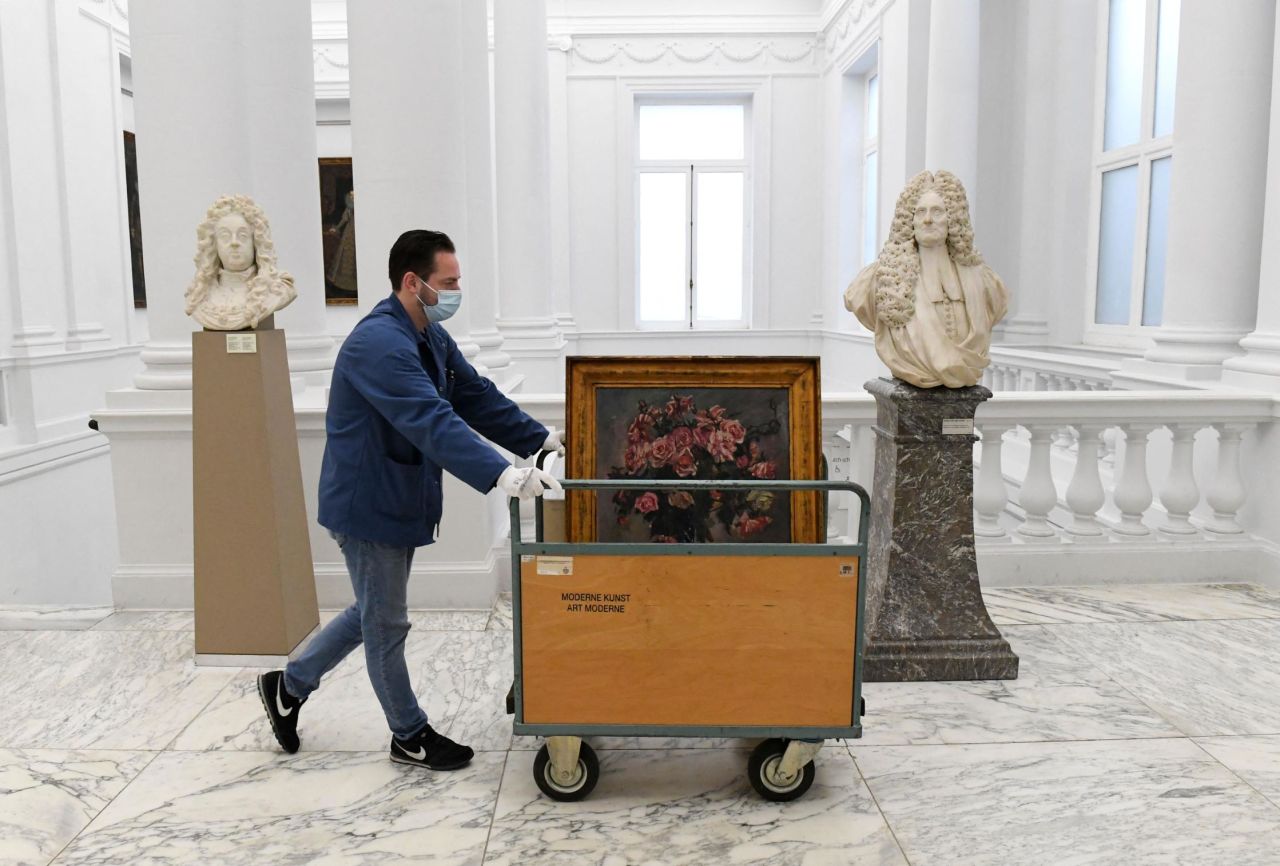A staff member at the Royal Museums of Fine Arts wheels the painting away to be packed. 