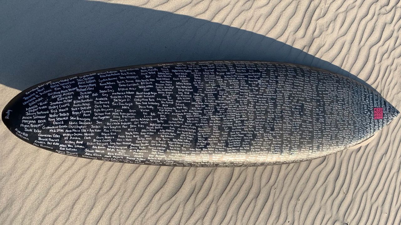 Fischer's surfboards are covered with hundreds of names of departed loved  ones.
