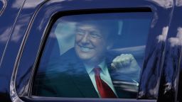 Outgoing US President Donald Trump waves to supporters lined along on the route to his Mar-a-Lago estate on January 20, 2021 in West Palm Beach, Florida. 