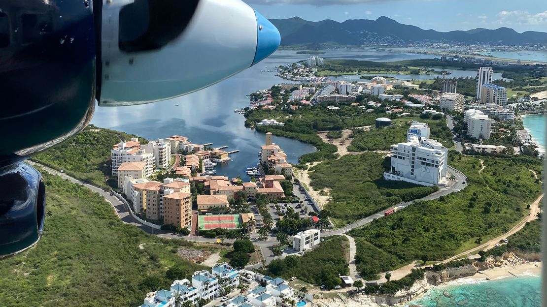 The flight comes in to land in Sint Maarten over Cupecoy Beach.