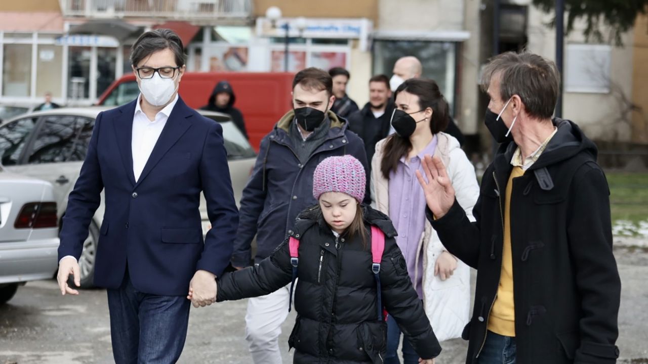 President Stevo Pendarovski held Embla Ademi's hand as he walked her to her school in the city of Gostivar on Monday. 