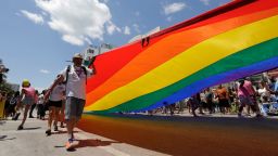 People with Safe Schools South Florida carry a rainbow flag at the annual Miami Beach Gay Pride Parade on April 9, 2017, in Miami Beach, Florida. (AP Photo/Lynne Sladky)