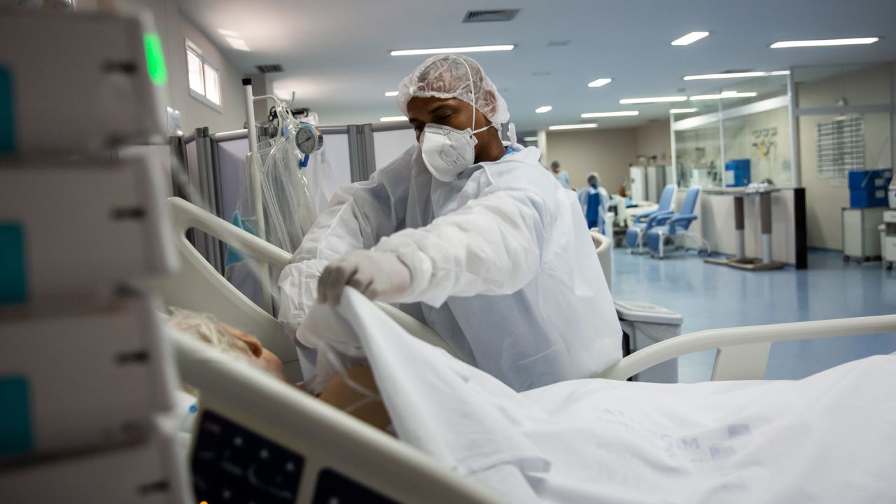 An ICU nurse in Marica, Brazil tends to a Covid-19 patient in January. 