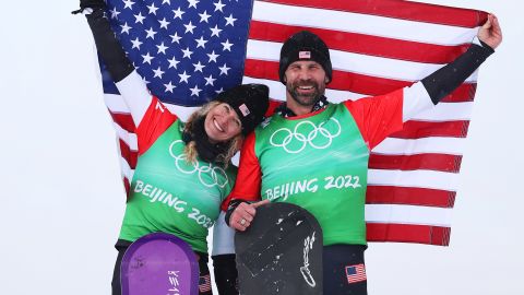 Gold medalists Lindsey Jacobellis and Nick Baumgartner of Team United States celebrate during the mixed team snowboard cross flower ceremony on Day 8 of the Beijing 2022 Winter Olympics on February 12, 2022.