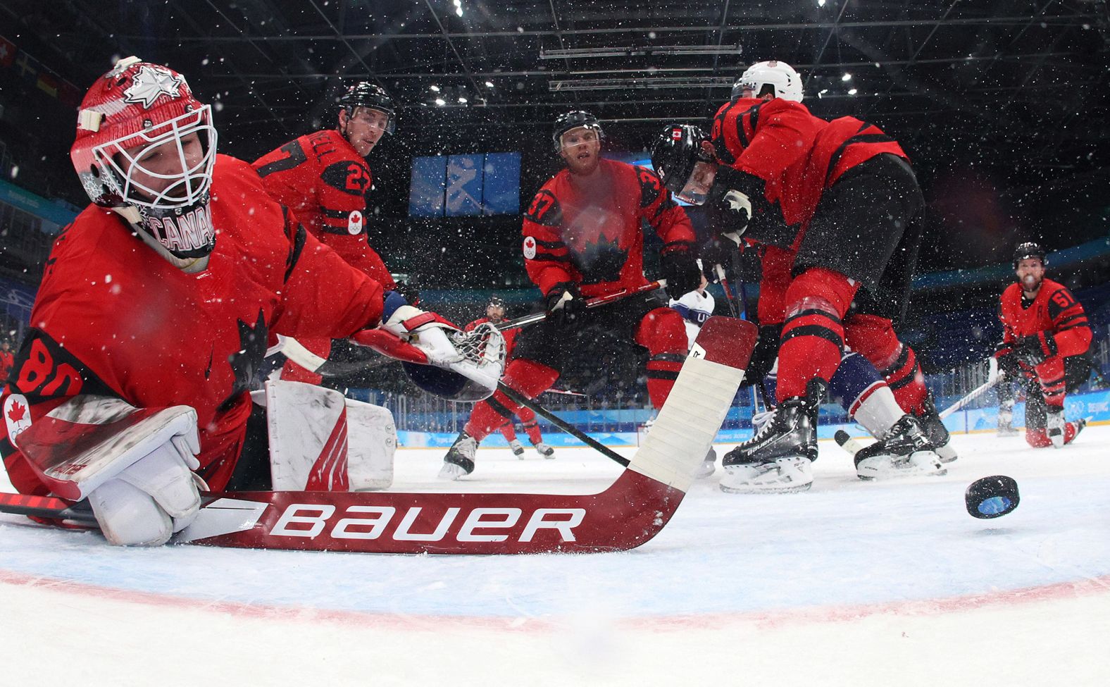 Canadian goaltender Eddie Pasquale can't get to a shot by the United States' Ben Meyers during the first period of their hockey game on February 12. The Americans won 4-2.