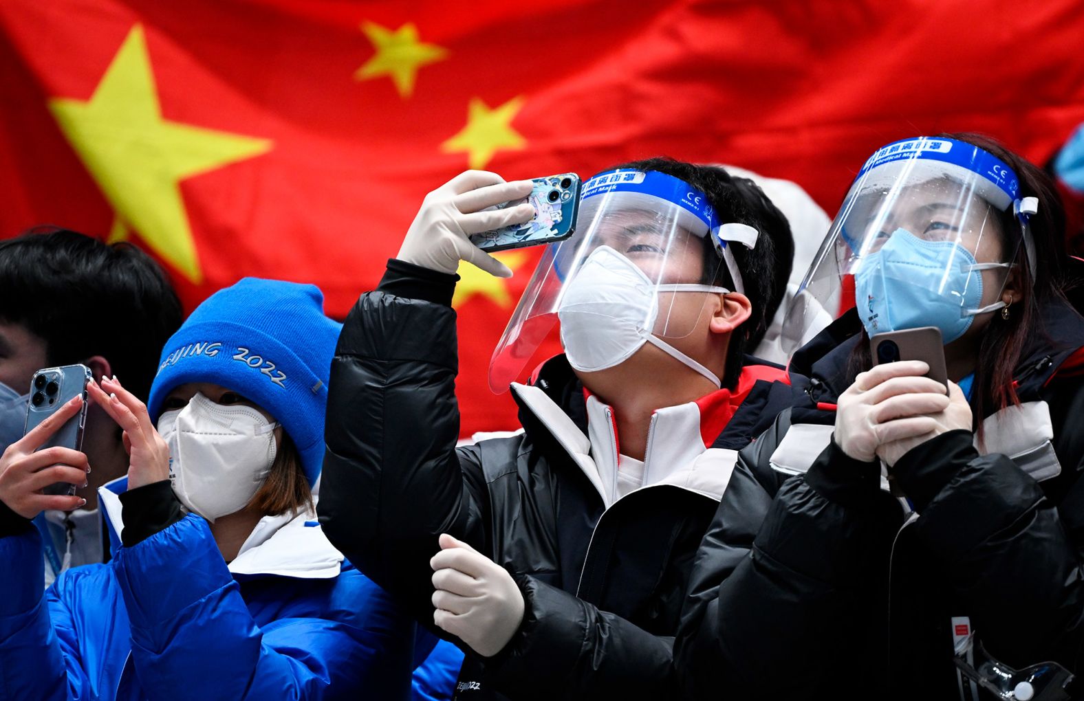 Fans celebrate after China's Yan Wengang won bronze in the men's skeleton event on February 11.