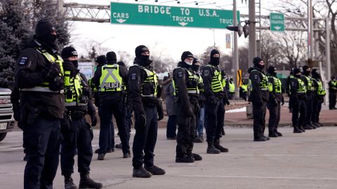Police line up in Windsor on Saturday morning in preparation to enforce an injunction against the demonstration near the Ambassador Bridge.