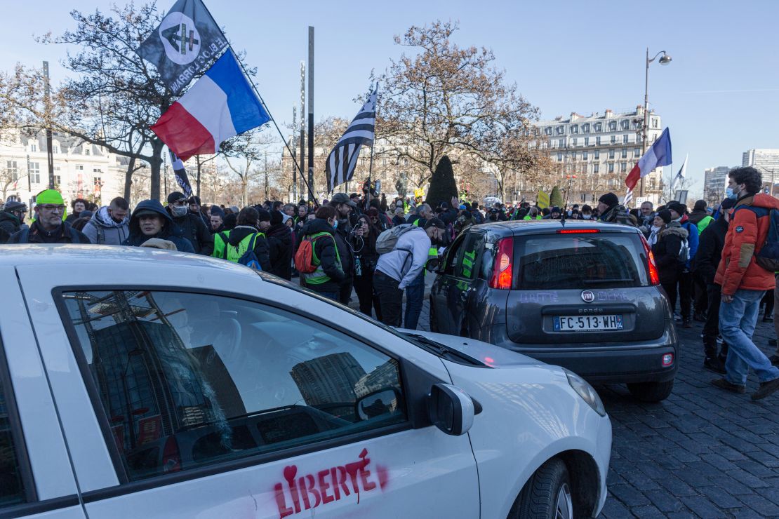 Members of the "Freedom Convoy" are greeted by supporters upon their arrival to Paris' Place D'Italie on Saturday.