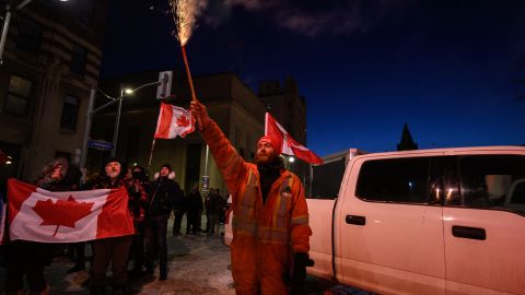 A protester lets off fireworks outside the Canada's parliament in Ottawa on Saturday.