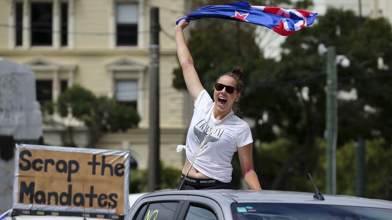 A protester waves a flag from the back of a vehicle in Wellington on Tuesday.