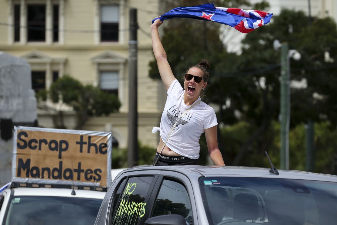 A protester waves a flag from the back of a vehicle in Wellington on Tuesday.