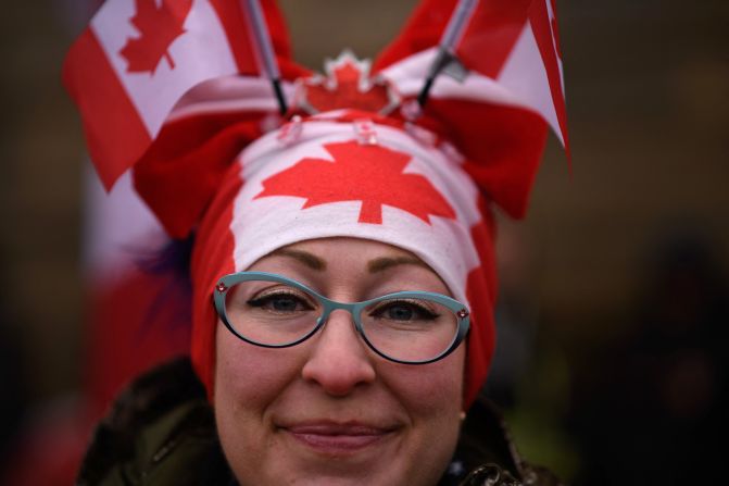 A protester wears Canadian flags on her head during a protest outside Parliament on February 11.