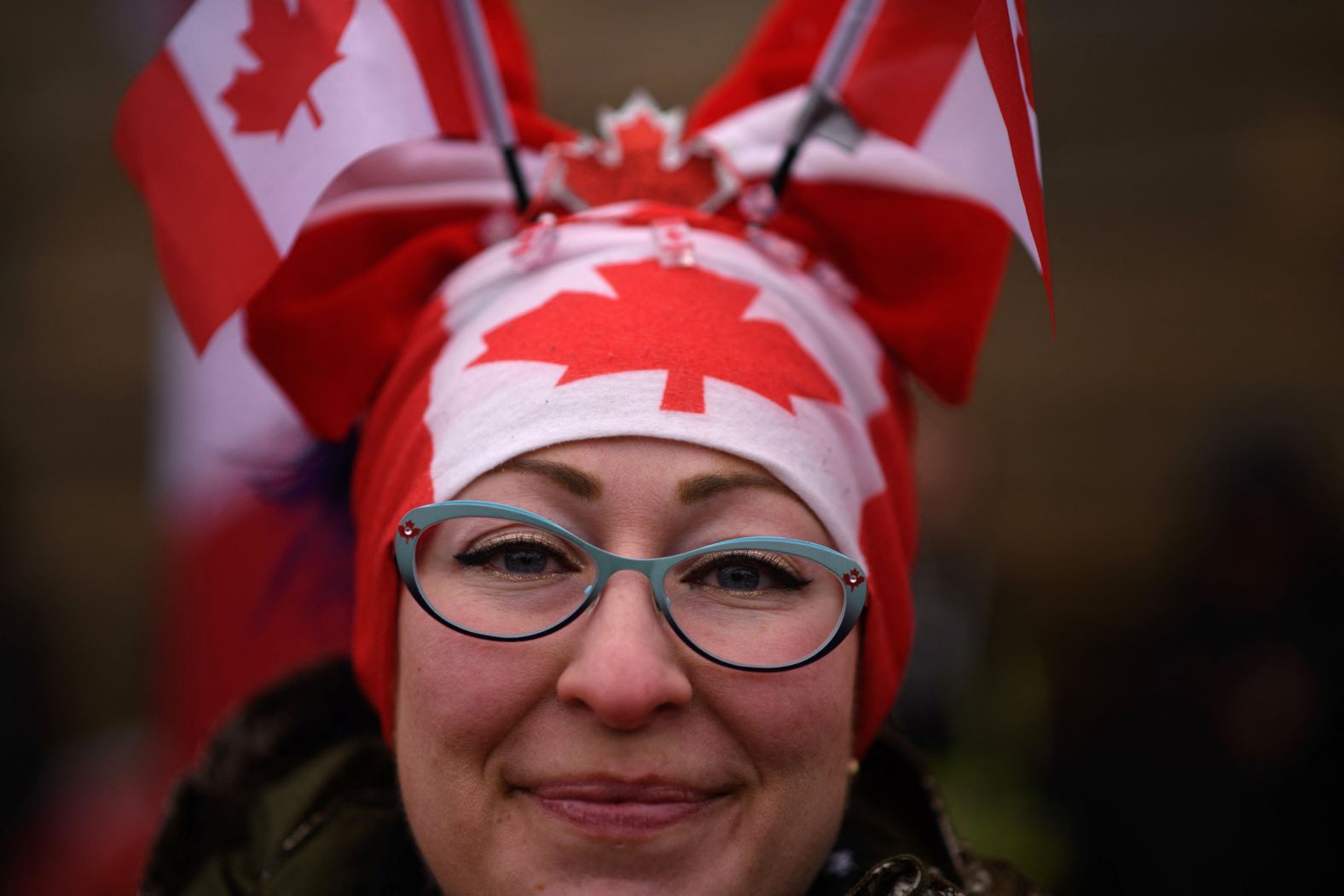 A protester wears Canadian flags on her head during a protest outside Parliament on February 11.