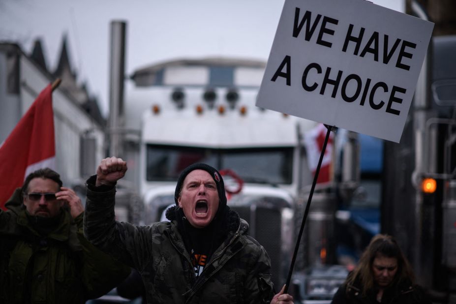 A demonstrator shouts during a protest outside Parliament on February 11. Canada's Ontario province declared a state of emergency over the trucker-led protests paralyzing the capital and blocking trade with the United States.